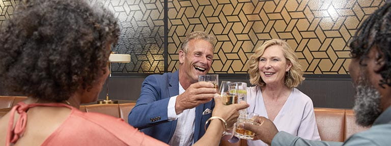 A group of passengers enjoying drinks in the North Cape Bar on Spirit of Adventure